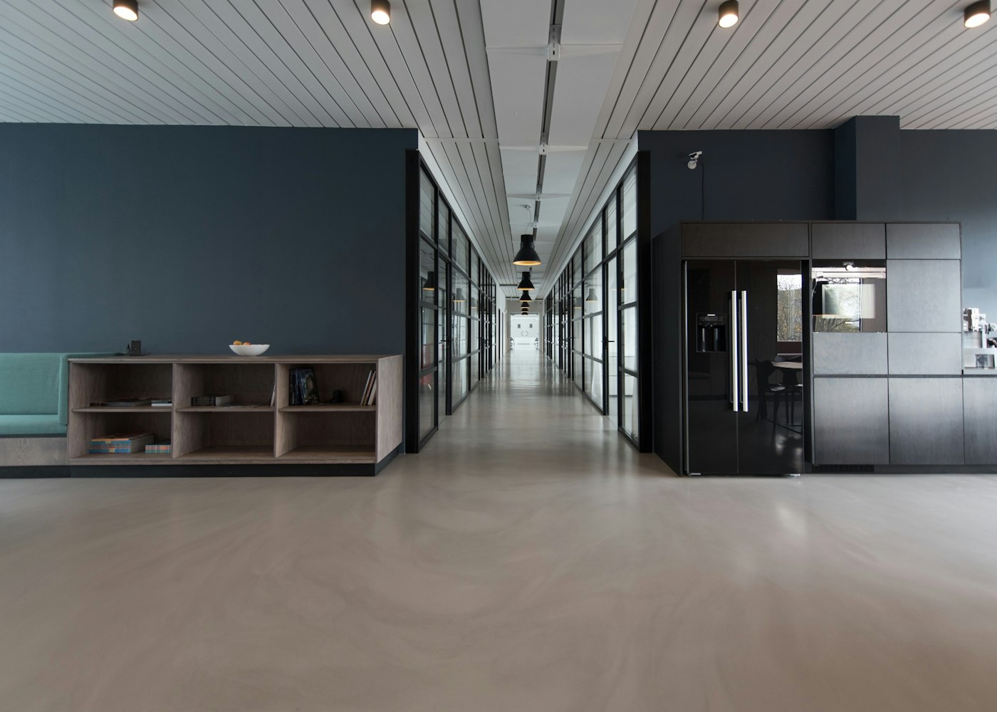 Modern office hallway with glass meeting rooms